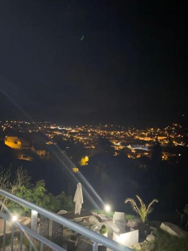 a woman standing on top of a hill at night at appartement la fleur d'abeille avec une belle vue et spa in Gérardmer
