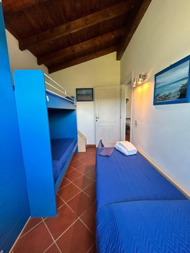 a room with a blue bed in a room at Lady Genny in Stintino