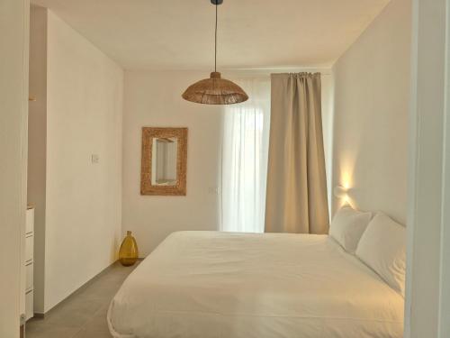 a bedroom with a white bed and a window at Casita Isabella in Vieste
