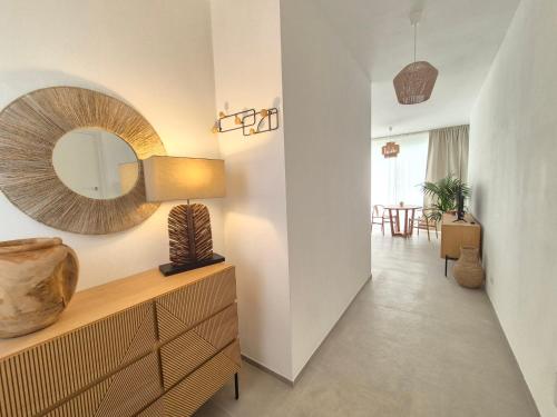 a hallway with a dresser and a mirror on the wall at Casita Isabella in Vieste