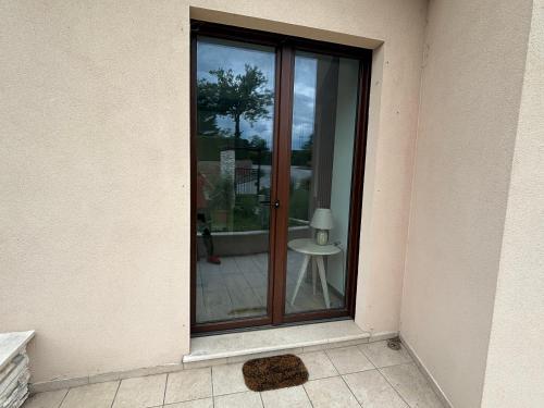 a glass door to a patio with a table at Casa vacanze Al Cielo in Sarnano
