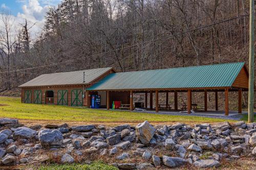 a building with a green roof and a stone wall at Attitude Adjustment by Eden Crest in Sevierville