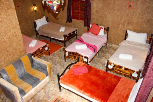 an overhead view of a room with three beds at Riad Soleil du Monde in Zagora