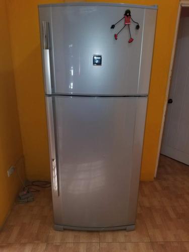 a silver refrigerator with a skeleton on the side of it at Queste Ochi Town House in Ocho Rios