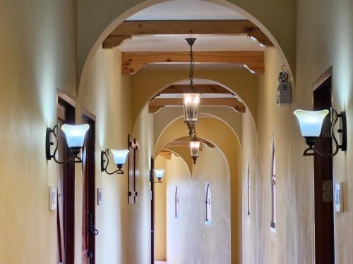 an aisle in a church with lights on the walls at Biciclette hotel khaoyai in Ban Bung Toei