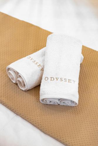 a towel with odyssey written on it sitting on a table at Odyssey Accommodation - Apartments in Pefkochori