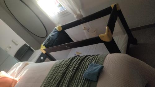 a bed in a small room with a mirror at Casa Cueva Las Chicas del Puente in Setenil