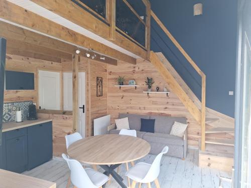 un salon avec une table et un canapé dans l'établissement Le bois dormant, à Samer