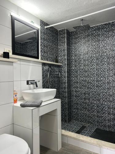 a bathroom with a toilet and a sink and a shower at Apartment Kuk in Split