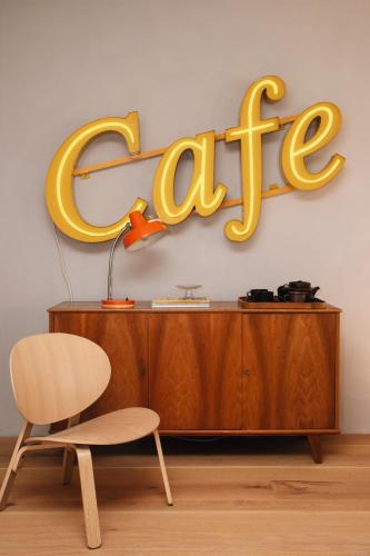 a sign for a store with a chair and a desk at Der Pfarrhof in Hartberg