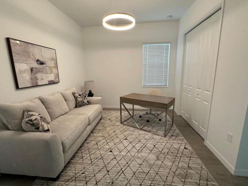 a living room with a couch and a table at New Pool Home in Ave Maria FL in Immokalee