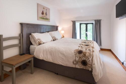 een slaapkamer met een groot bed en een raam bij Charming Guest House in Cornish Countryside in Bodmin