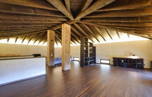 a large room with wooden floors and a large ceiling at Awesome Home In Paluzza in Paluzza