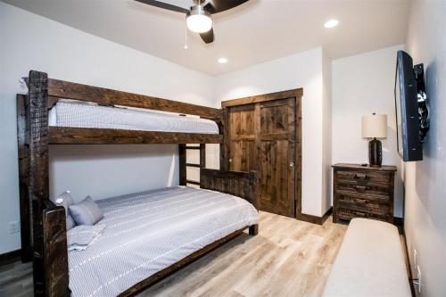 a bedroom with a bunk bed and a tv at Columbia Crest 301 in Columbia Falls