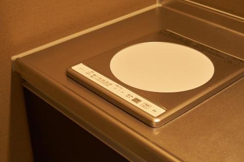 a remote control sitting on top of a table at BbyC Hotel 那覇 レンタカー付ホテル in Naha
