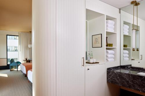 a bathroom with a white cabinet and a sink at Hotel Henrietta in New Orleans