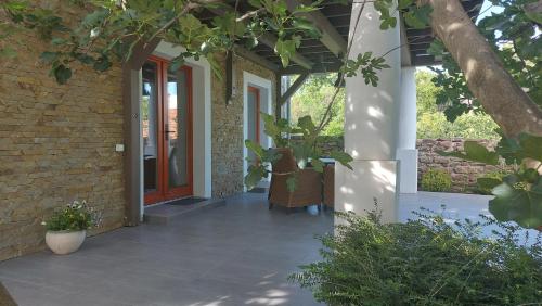a front door of a house with a plant at Kikelet Udvarház in Zánka