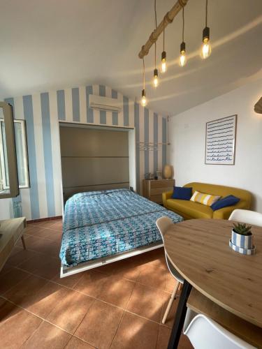 a bedroom with a bed and a table in it at WildSunset in Monte Argentario