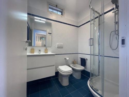 a bathroom with a toilet and a sink and a shower at WildSunset in Monte Argentario
