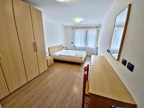 Pokój z sypialnią z łóżkiem i biurkiem w obiekcie Alpe Di Gries Sella Ronda Dolomiti w mieście Canazei
