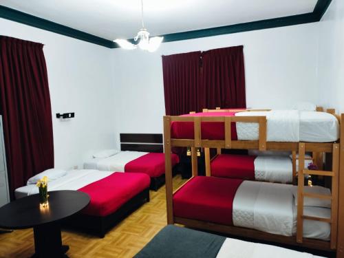 a room with two bunk beds and a table at GREEN ORCHID HOSTEL Miraflores Lima in Lima