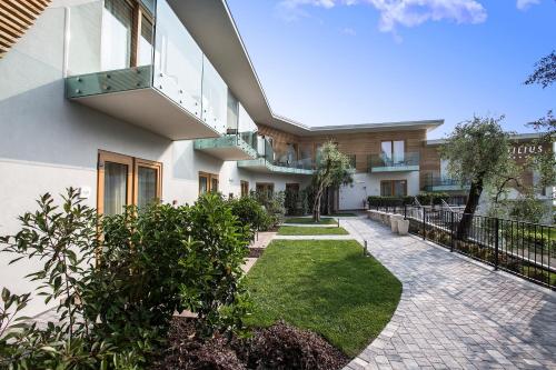 a courtyard of a building with a walkway at Hotel Atilius - Adults Only in Limone sul Garda