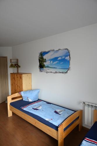 a bed in a room with a picture on the wall at Monteure sind HERZLICH WILLKOMMEN! in Mittenwalde