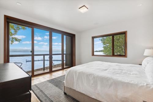 a bedroom with a bed and a large window at Swan Lake House in Bigfork