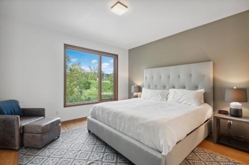 a bedroom with a large bed and a window at Swan Lake House in Bigfork