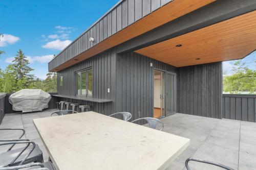 an outdoor patio with a table and chairs at Swan Lake House in Bigfork