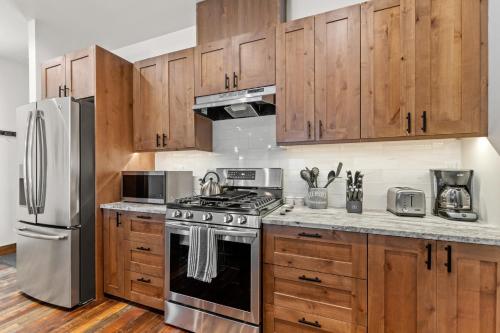 a kitchen with wooden cabinets and stainless steel appliances at Baker Loft 201 in Whitefish