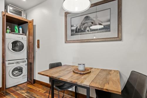 a dining room with a table and a washer and dryer at Baker Loft 201 in Whitefish