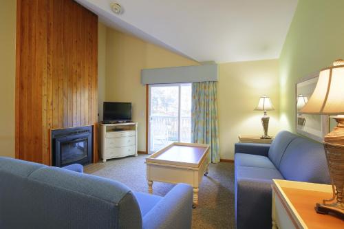a living room with a couch and a fireplace at Ocean Pines Resort in Duck