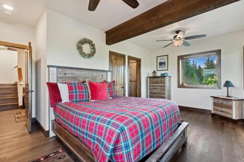 a bedroom with a bed and a ceiling fan at Big Sky Lookout in Whitefish