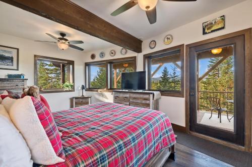 a bedroom with a bed and a tv and windows at Big Sky Lookout in Whitefish