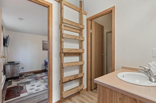 a bathroom with a ladder next to a sink at Big Sky Lookout in Whitefish