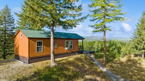 a tiny house on a hill with trees at Big Sky Lookout in Whitefish