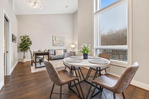 a dining room and living room with a table and chairs at Frisco Stay- 0 1Mi to MTB trail Walk to DT Fay in Fayetteville