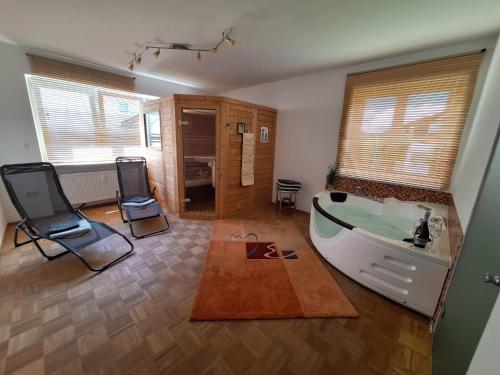 a living room with a tub in the middle of it at FeWo Ruhepo(o)l inkl. Sauna in Großmehring