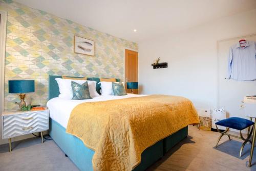 a bedroom with a large bed with a yellow blanket at Dream Stays Bath - Haringtons Place in Bath