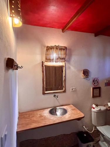 a bathroom with a sink and a mirror on the wall at Pousada Maresia in Atins