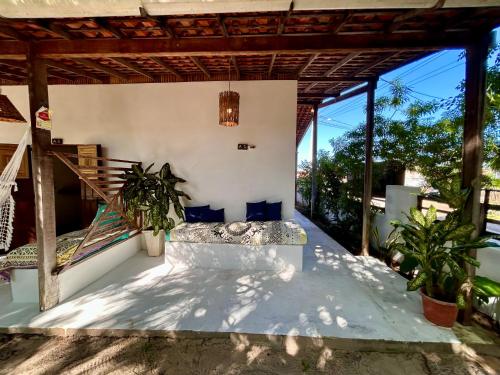 an outdoor living room with a bench on a patio at Pousada Maresia in Atins