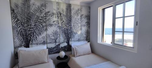 a living room with a couch and a wall mural at Furna Blue View in Lagoa