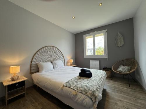 a bedroom with a large bed and a window at Maison des tourelles - 6pers - WiFi - Rêve au Mans in Arnage
