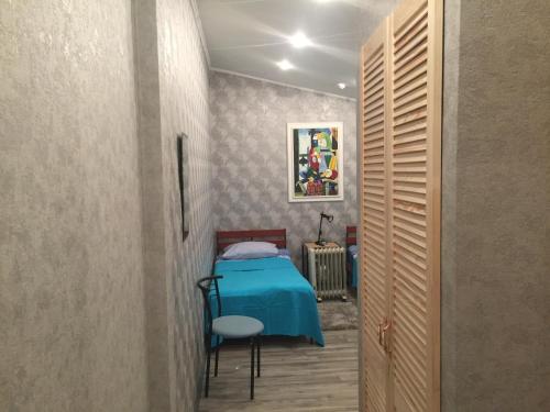 a bedroom with a blue table in a room at YELLOW UNLIMITED HOTEL 4 in Kharkiv