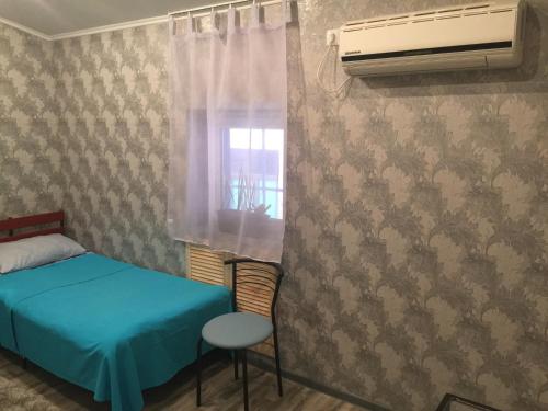 a small bedroom with a bed and a window at YELLOW UNLIMITED HOTEL 4 in Kharkiv