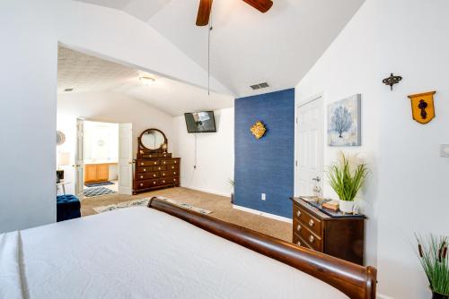 a bedroom with a bed and a blue wall at Atlanta-Area Home with Yard about 2 Mi to Six Flags in Austell
