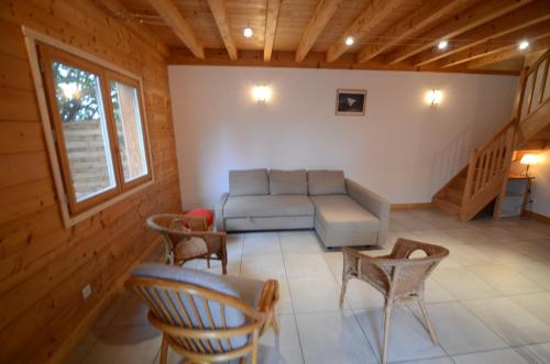 a living room with a couch and chairs at Chalet Silene in Le Bourg d'oisans