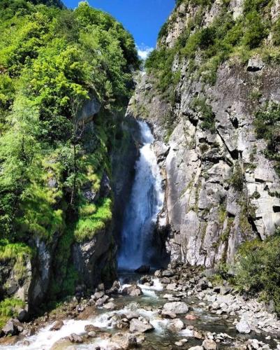 a waterfall in the middle of a rocky mountain at Chalet Silene in Le Bourg d'oisans