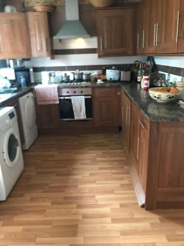 a kitchen with a stove and a dishwasher at 31 Stonelea court in Meanwood